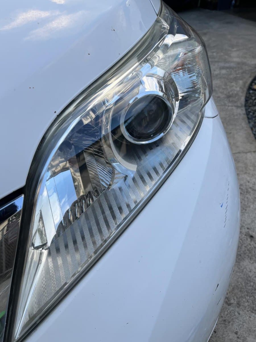The same headlight after restoration — clear lens, sharp projector